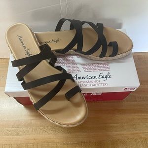 Black flat strappy sandal. Never worn. New with tags and box